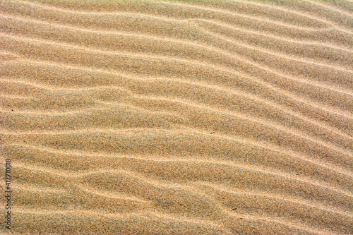Fine beach sand in the summer sun. Sand texture. Sandy beach for background. Top view.