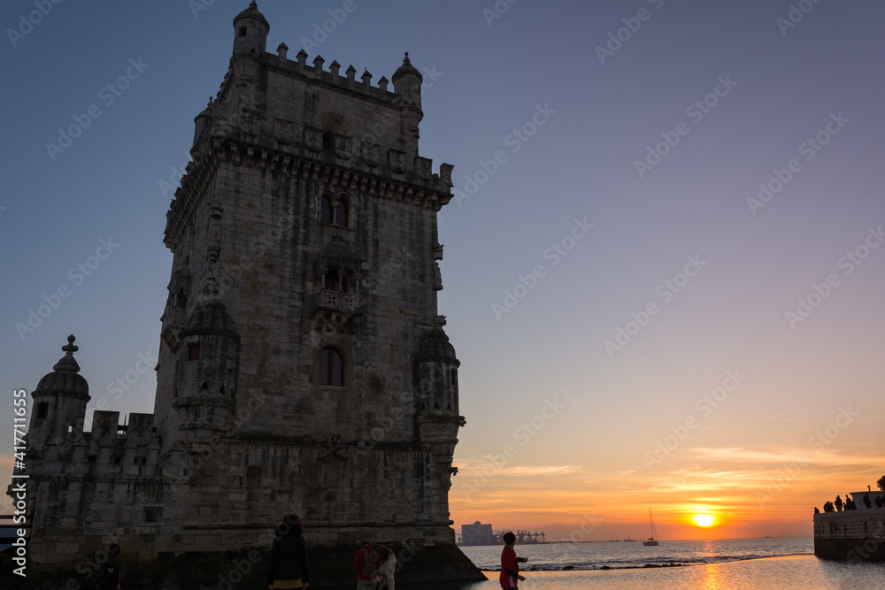 Beautiful views of Belem Tower in Lisbon city, it is a UNESCO World Heritage Site, People having fun next to the river Tagus Beautiful views of Belem Tower in Lisbon city, it is a UNESCO World Heritage Site, People having fun next to the river Tagus