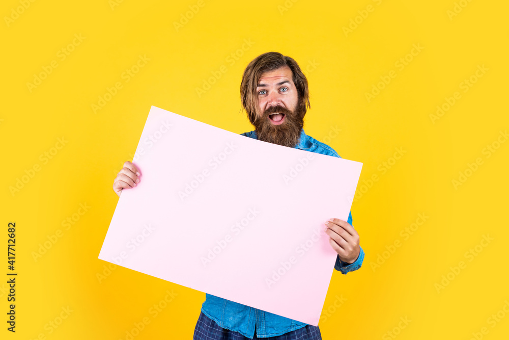 caucasian hipster with beard and stylish hair hold paper banner with copy space, ad caucasian hipster with beard and stylish hair hold paper banner with copy space, ad