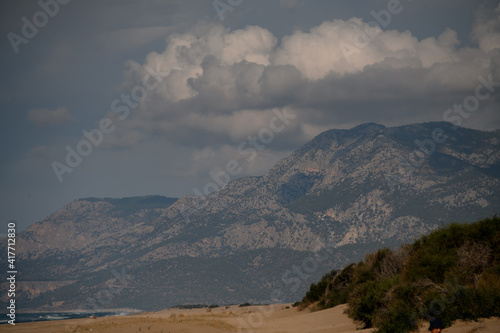 magnificent view of sea coast and high mountain and sky with white clouds