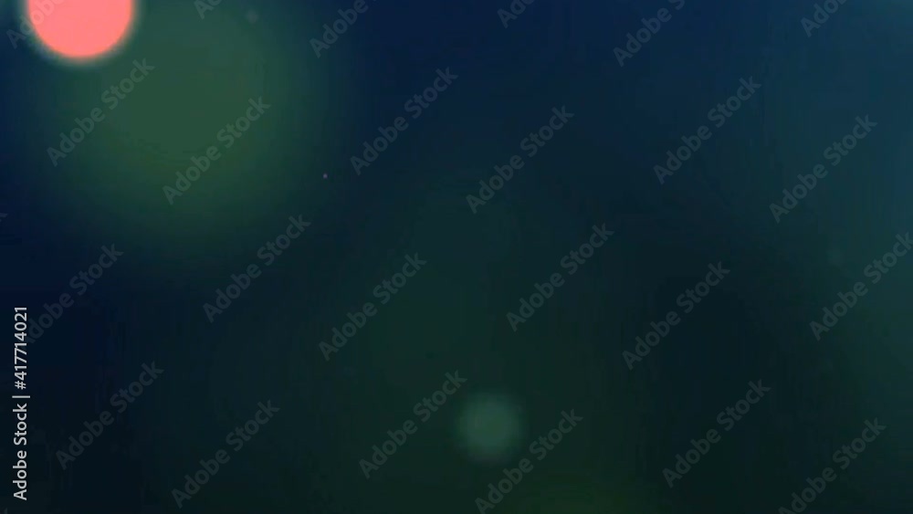 Multicolored light highlights with dust particles in motion on a black background Multicolored light highlights with dust particles in motion on a black background