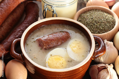 Sour rye soup with sausage and egg with the ingredients used in its preparation