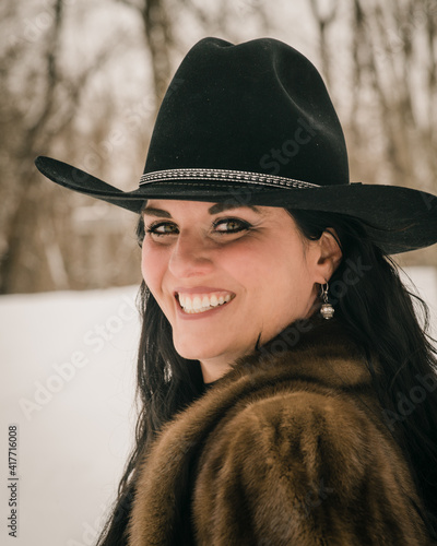 outdoor portrait of woman in cowboy hat and fur coat