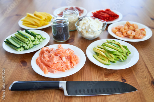 sushi ingredients placed on the wooden table. prepared for sushi making at home photo