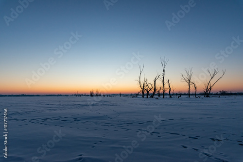 just before sunrise over the frozen river