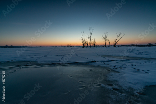 just before sunrise over the frozen river