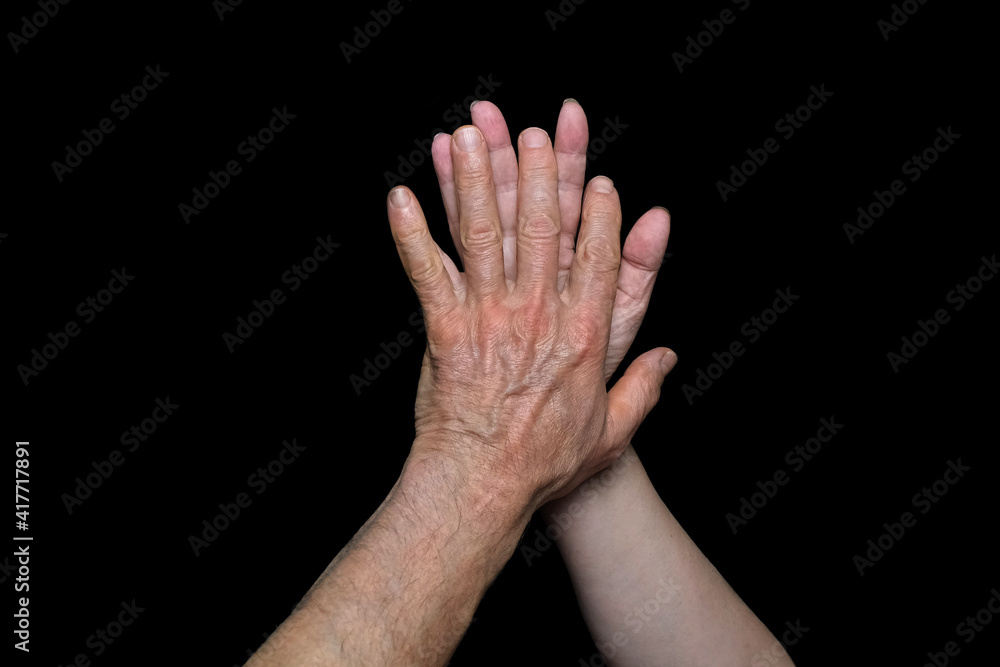 male and female hands together on black background, old skin with wrinkles and veins, concept of health, age-related changes, love, tender relationship of a couple in love, isolated image male and female hands together on black background, old skin with wrinkles and veins, concept of health, age-related changes, love, tender relationship of a couple in love, isolated image