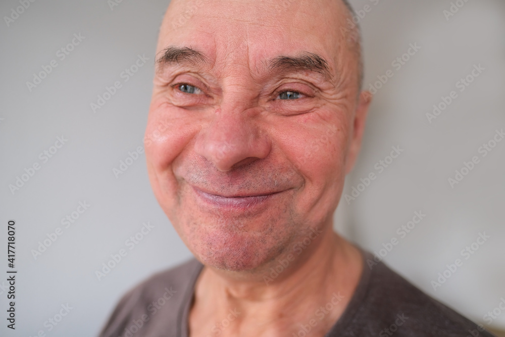 face of European old man close up, wrinkles on aging skin, smiling, good mood concept, cosmetology, age-related changes face of European old man close up, wrinkles on aging skin, smiling, good mood concept, cosmetology, age-related changes