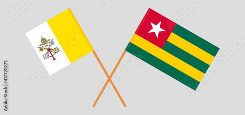 Crossed flags of Vatican and Togo. Official colors. Correct proportion