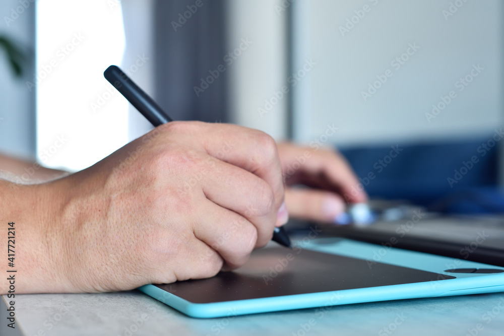 Designer hands drawing on digital graphic tablet Designer hands drawing on digital graphic tablet