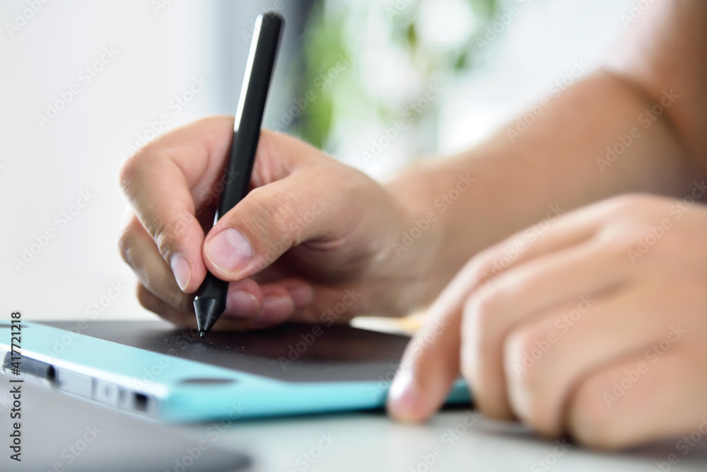 Designer hands drawing on graphic tablet Designer hands drawing on graphic tablet