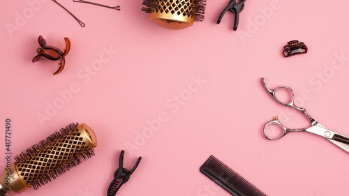 Stop motion animation of professional hair cutting shears comb for separating hair hairpins section hair clips and gold round hair brush for styling with pink colorized. Hairdresser salon equipment