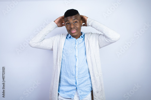 Young handsome african american man wearing casual clothes relaxing and stretching, arms and hands behind head and neck smiling happy