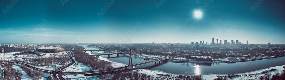 Beautiful panoramic winter aerial drone view to Warsaw city center with skyscrapers and Swietokrzyski Bridge (En: Holy Cross Bridge) - is a cable-stayed bridge over the Vistula river in Warsaw, Poland