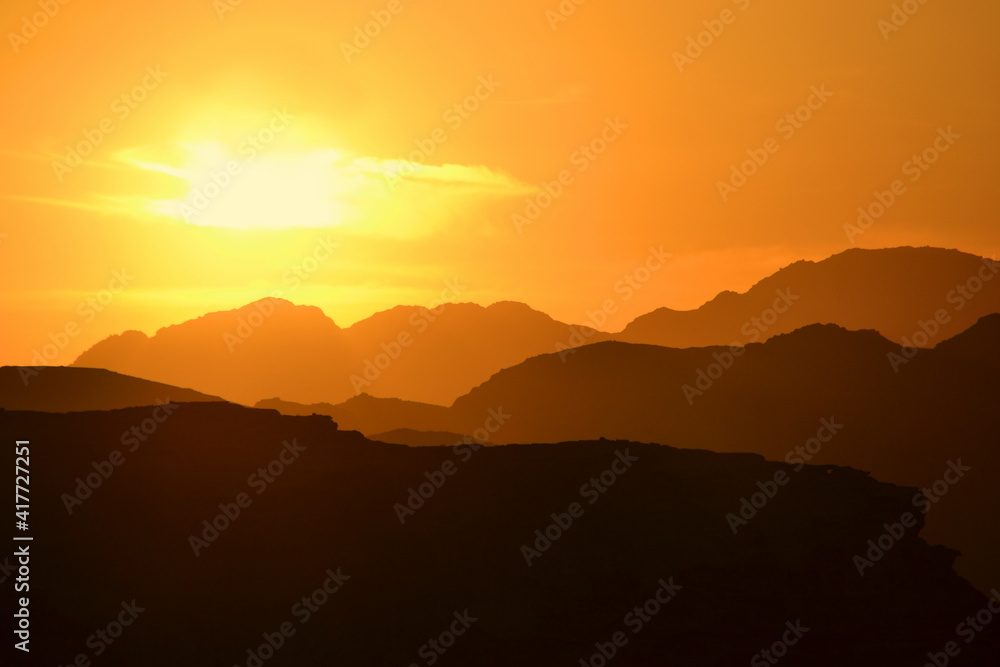 Beautiful sunset in the Wadi Rum desert. The early evening sun illuminates the mountains and valleys.