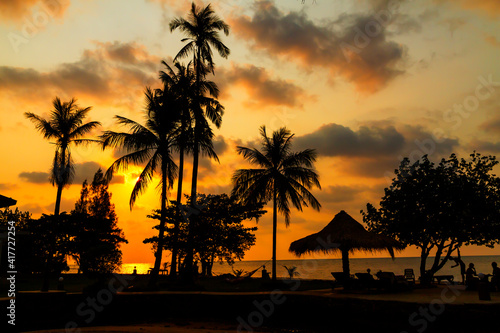 Sunset with silhouette coconut on Bailan beach