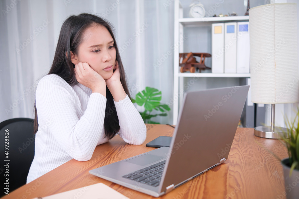 Stressful anxious young Asian woman enthusiastic watching video call conference online internet movie entertainment home living relaxing lifestyle, student online class learning education quarantine Stressful anxious young Asian woman enthusiastic watching video call conference online internet movie entertainment home living relaxing lifestyle, student online class learning education quarantine