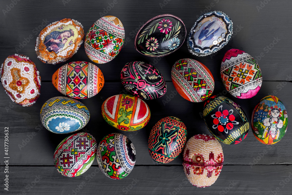 Easter eggs on a black wooden background, multicolored