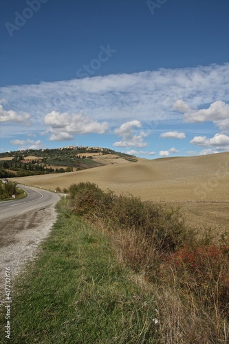 Tuscany, Italy. Rural road towards medieval town.