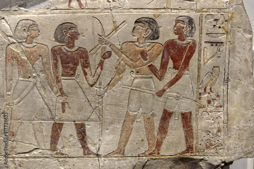 an Egyptian stele depicting hunters with bows photo