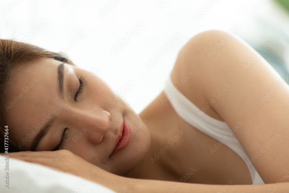 Asian women sleeping and sweet dream on white bed in bedroom Asian women sleeping and sweet dream on white bed in bedroom