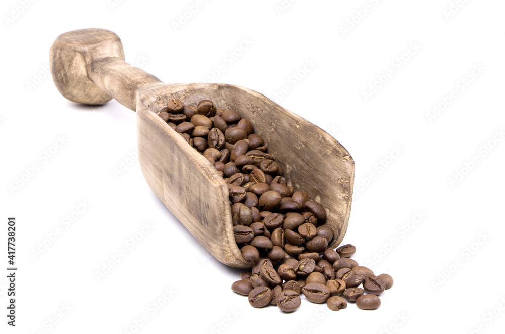 Coffee beans in a wooden scoop isolated on a white background. Roasted coffee beans isolated. A wooden scoop with coffee