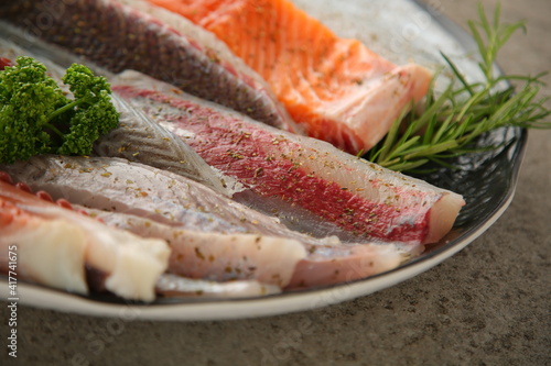 Canvas Print Seasoned seafood with fresh octopus, salmon, tuna and flatfish in one plate