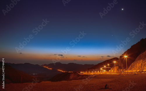  light trails and early morning wide view of Jebel Jais mountain, united arab emirates