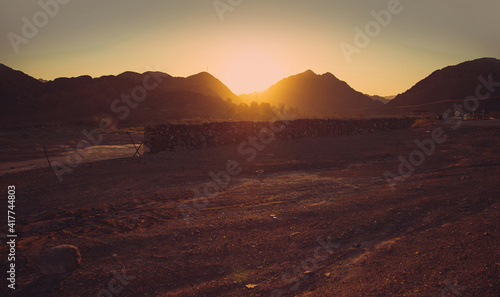 Golden sunset over the mountains in the wild desert. RAK  UAE