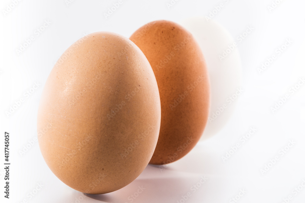 Three (3) different shades of natural organic eggs on a white background. Diversity and difference concept Three (3) different shades of natural organic eggs on a white background. Diversity and difference concept