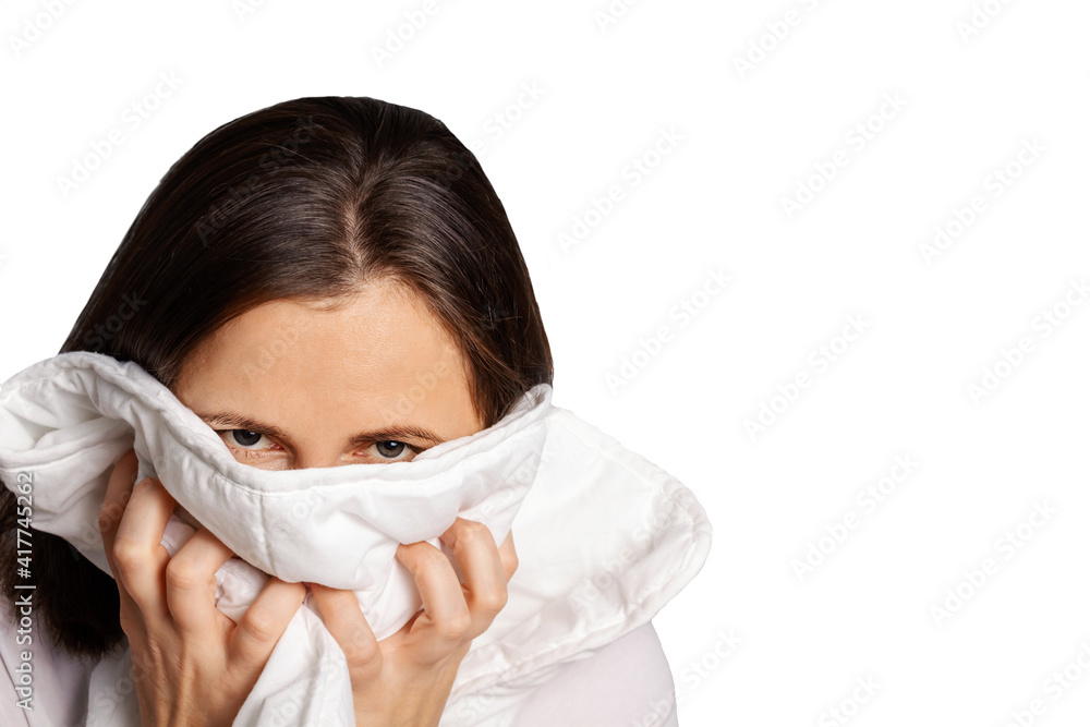 Isolated on white caucasian woman suffers from intense toothache. Woman presses blanket to her face to reduce the pain. Isolated on white caucasian woman suffers from intense toothache. Woman presses blanket to her face to reduce the pain.