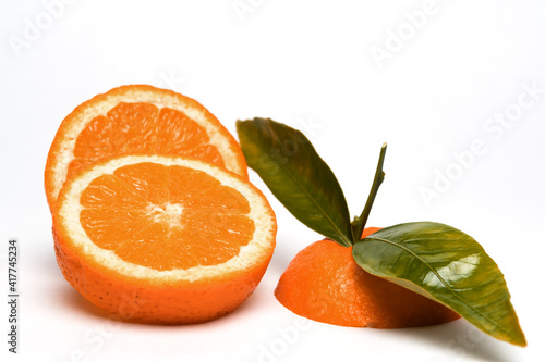 Fototapeta Naklejka Na Ścianę i Meble -  Cut Orange fruit with leaves isolated on white.Copy space