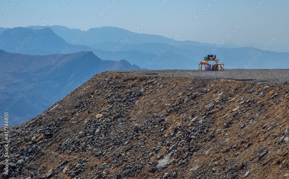 A picnic table at the edge of a cliff in Jebel Jais mountain in Ras Al Khaimah

