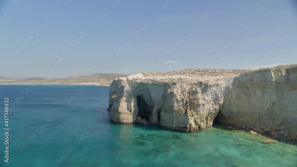 Flying Towards a Cave on an Aegean Sea Beach in the Island of Milos Flying Towards a Cave on an Aegean Sea Beach in the Island of Milos