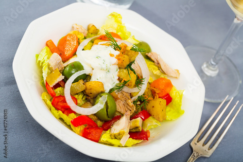 Homemade salad with chicken, eggplant, lettuce, red bell pepper, carrot and dill