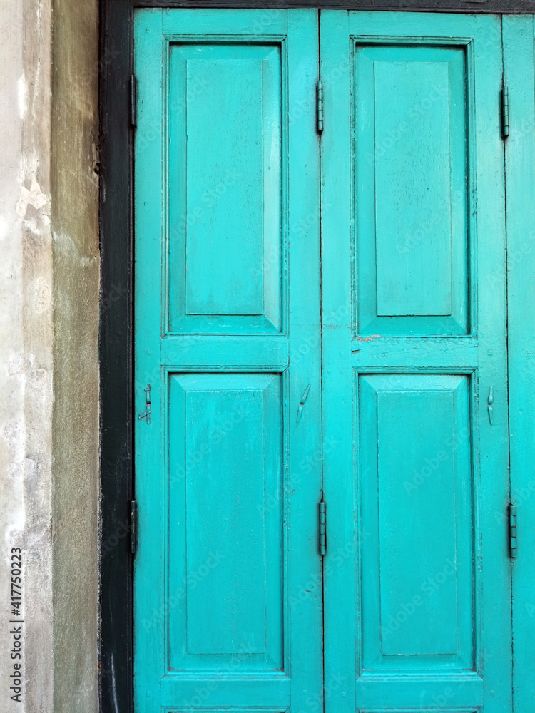 Old rustic wooden doors painted in blue.