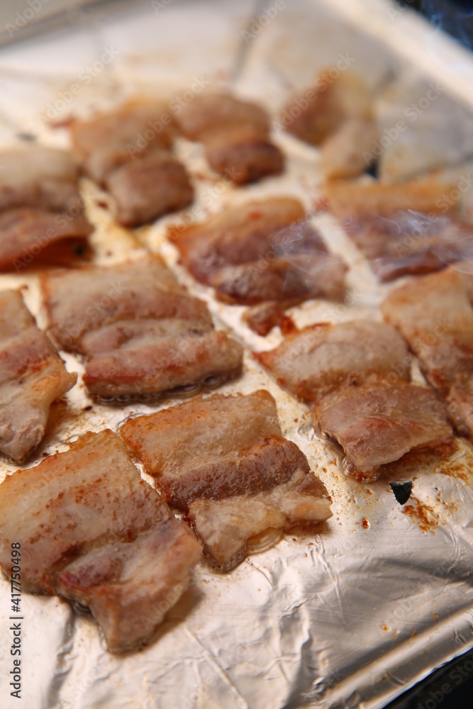 Frozen pork belly is getting cooked on foil. 호일위에 냉동삼겹살이 익어가는 모습 Frozen pork belly is getting cooked on foil. 호일위에 냉동삼겹살이 익어가는 모습