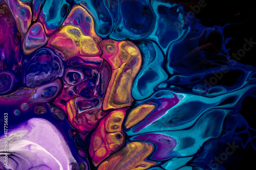 Bright abstract fluid art on black background dark purple and blue colors. photo