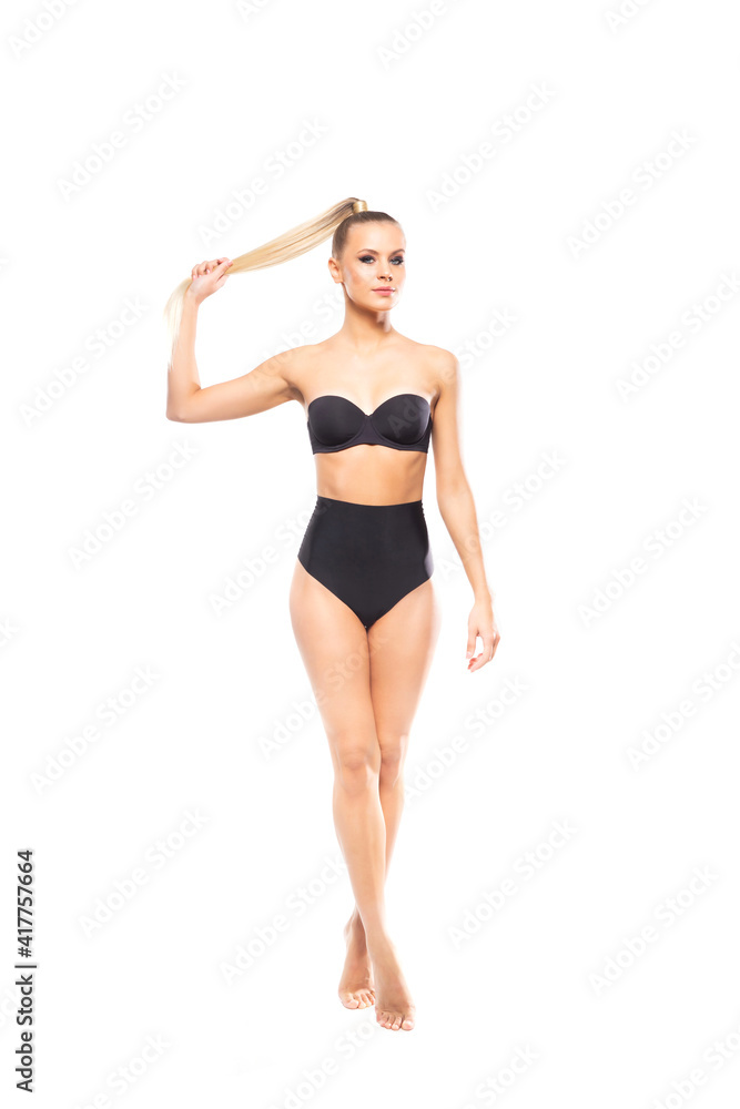 Young, fit and beautiful blond woman in white swimsuit isolated on white background. Healthcare, diet, sport and fitness.