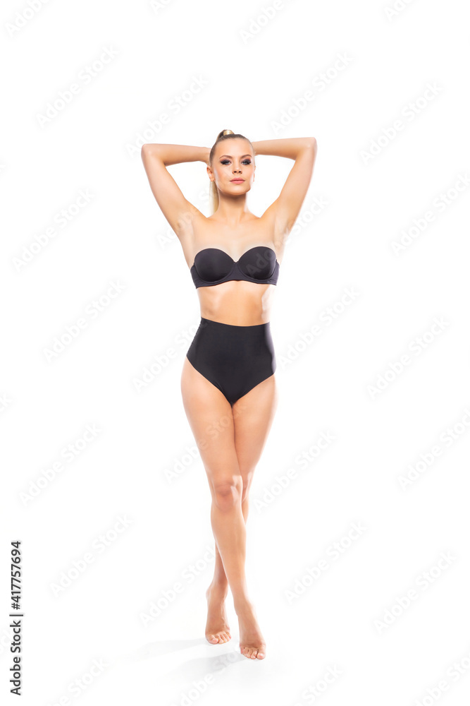Young, fit and beautiful blond woman in white swimsuit isolated on white background. Healthcare, diet, sport and fitness. Young, fit and beautiful blond woman in white swimsuit isolated on white background. Healthcare, diet, sport and fitness.
