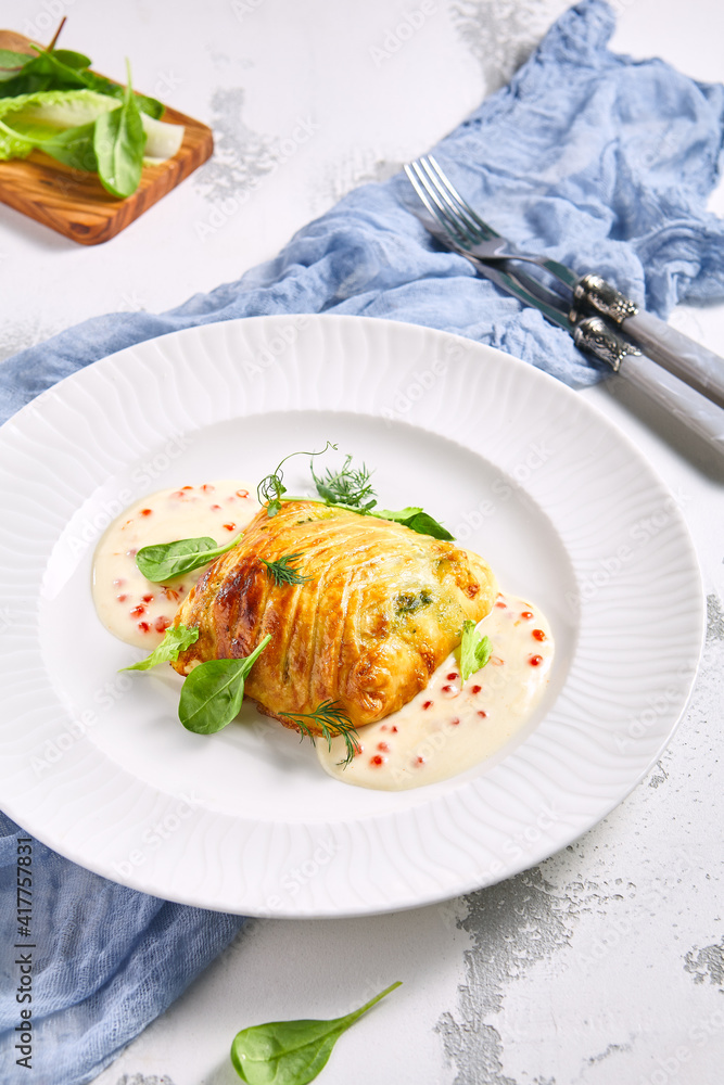 Zander Fish Baked in Dough with Caviar and Cream Sauce. Restaurant food plate on white table. Delicious baked fish meal. Zander Fish Baked in Dough with Caviar and Cream Sauce. Restaurant food plate on white table. Delicious baked fish meal.