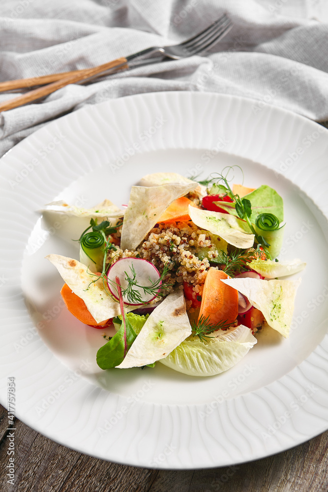 Quinoa Salad with Veggies. Restaurant vegetarian food plate on wooden table. Vegetables, healthy, organic dinner concept Quinoa Salad with Veggies. Restaurant vegetarian food plate on wooden table. Vegetables, healthy, organic dinner concept