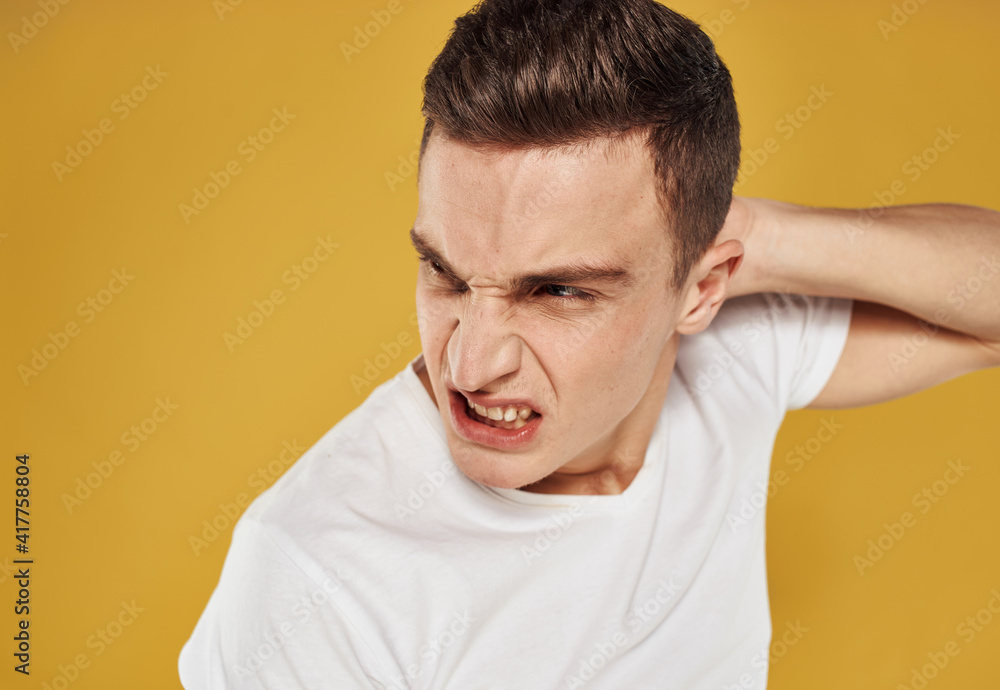 Obraz premium Aggressive man touches his head emotions model irritability