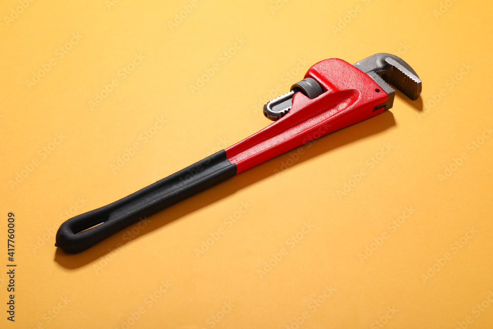 Plumbing wrench on color background Plumbing wrench on color background