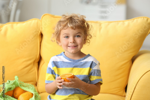 Cute little boy with orange...