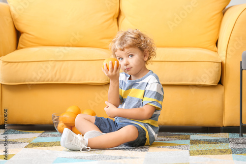 Cute little boy with orange...