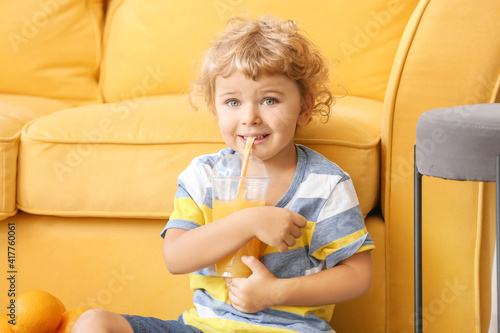 Cute little boy drinking or...