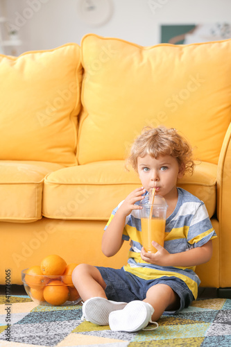Cute little boy drinking or...