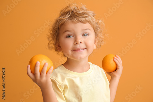 Cute little boy with orange...