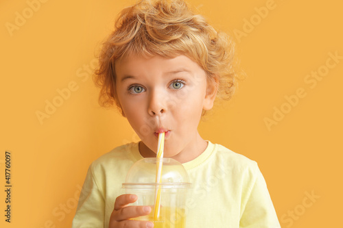 Cute little boy drinking or...